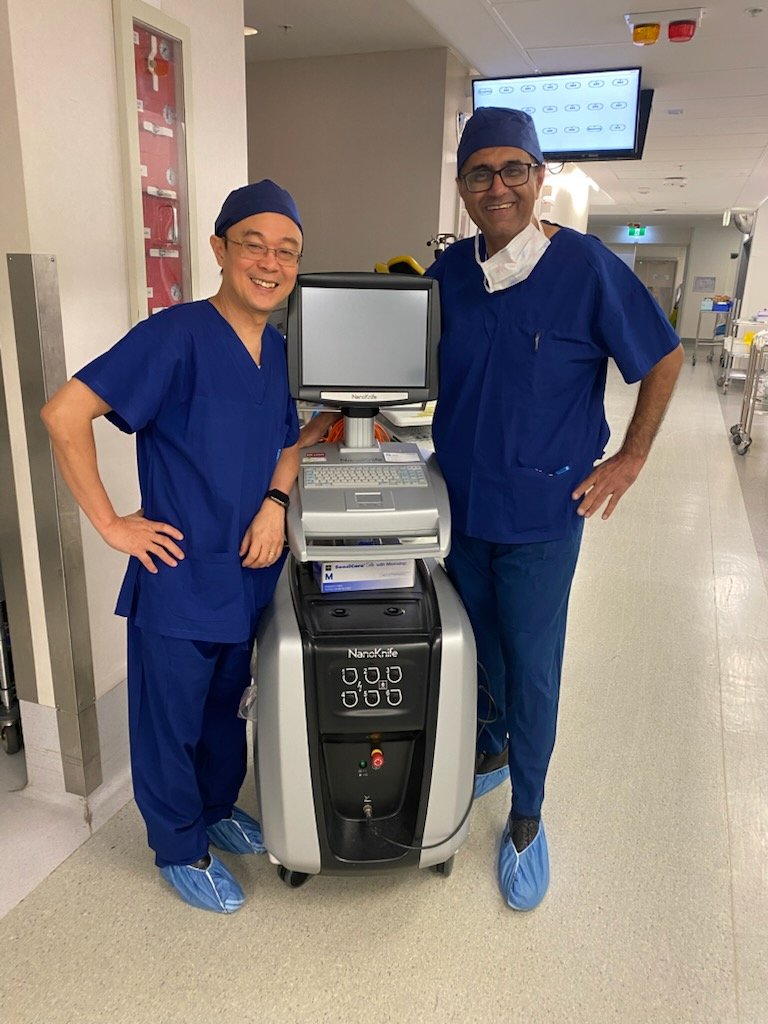Dr Raji Kooner with a colleague beside the NanoKnife pulse generator outside the operating theatre