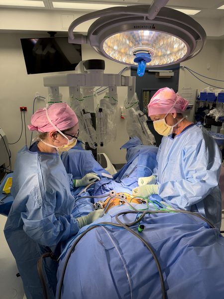 Theatre team beside robotic equipment